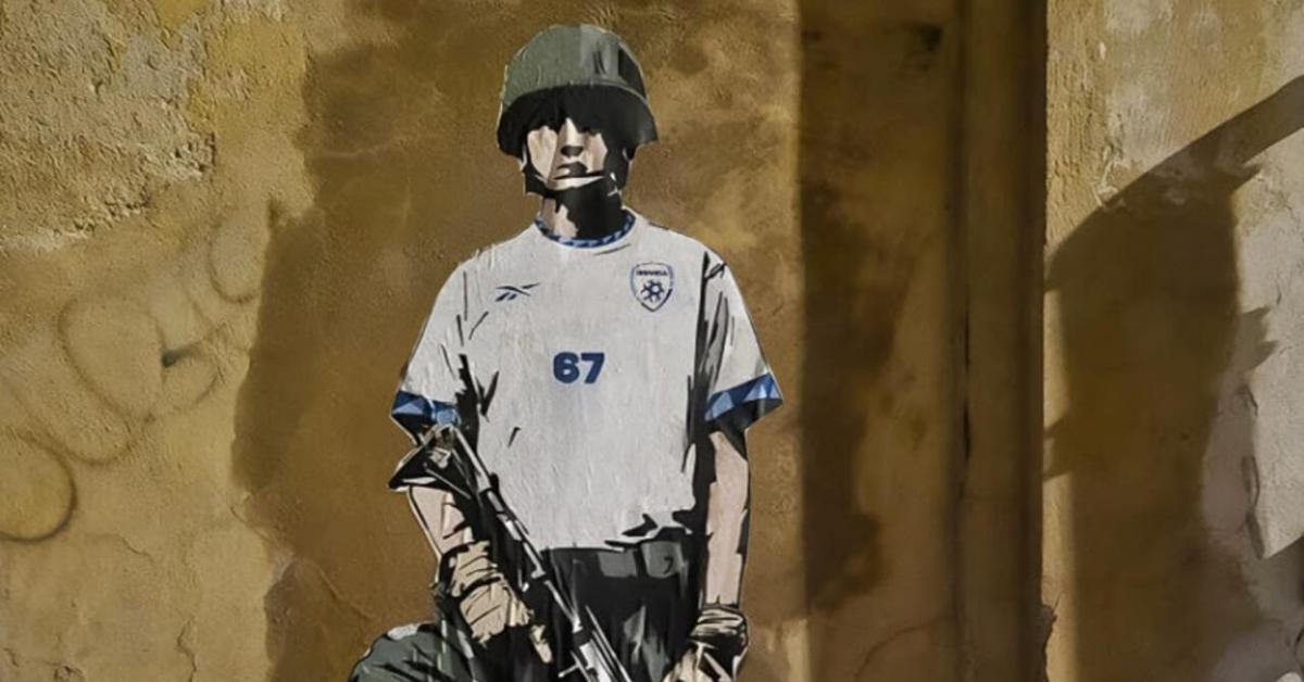 Roma, la nuova opera di Laika "The Bloody Match" contro partita Italia Israele davanti a sede FIGC: calciatore israeliano con fucile ed elmetto