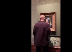 Ambientalisti si attaccano con la colla al dipinto "La ragazza con l'orecchino di perla" di Vermeer - VIDEO